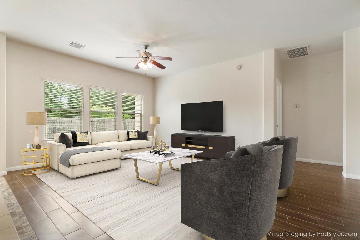 615 Timberstand Lane Spring, TX 77373 - Photo 3 of 19 Discover a beautifully virtually staged, spacious family room featuring elegant wood plank tiles, perfect for modern living and entertaining.