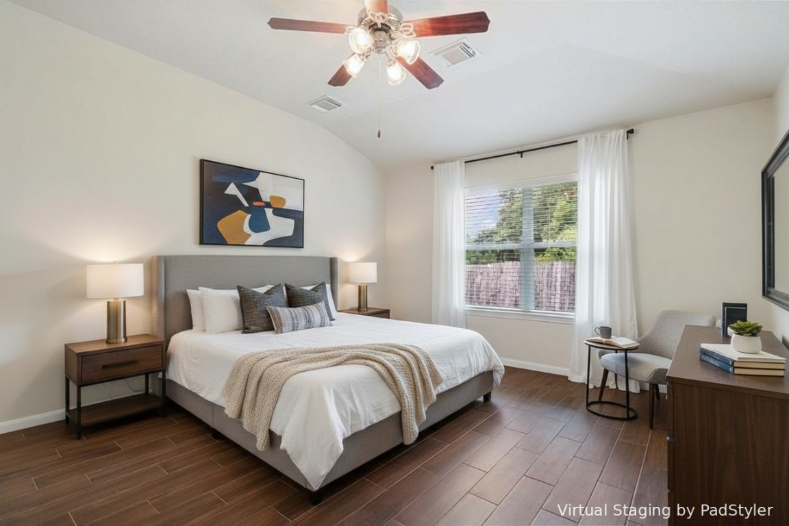 615 Timberstand Lane Spring, TX 77373 - Photo 10 of 19 Experience the inviting elegance of this virtually staged primary bedroom, featuring warm wood tile floors, abundant natural light, creating a serene retreat.