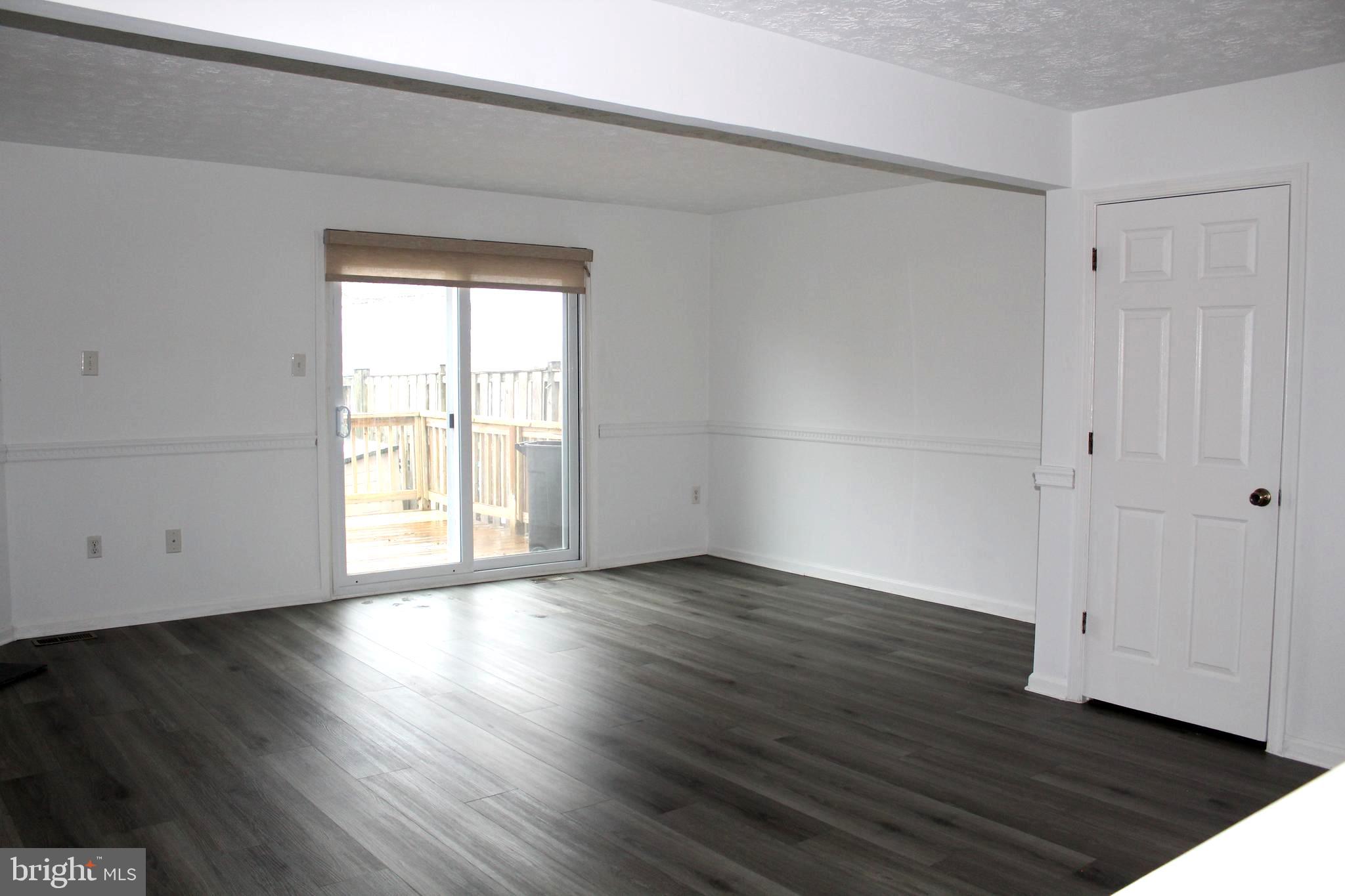 4973 Pintail Court Frederick, MD 21703 - Photo 11 of 28 an empty room with wooden floor and windows