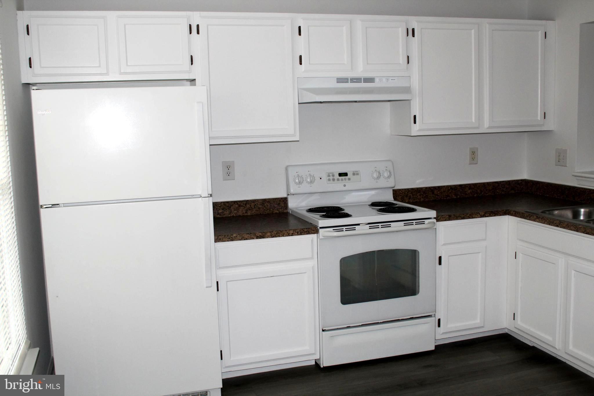 4973 Pintail Court Frederick, MD 21703 - Photo 3 of 28 a white refrigerator freezer and white cabinets