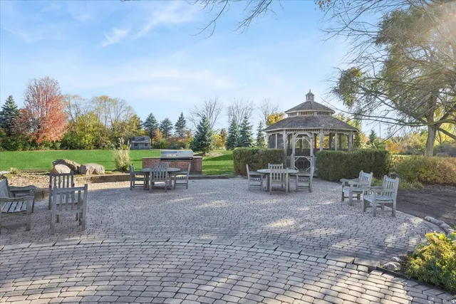 a view of a house with backyard sitting area and garden