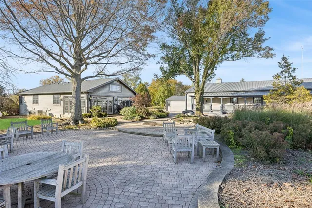 a view of a house with backyard and sitting area