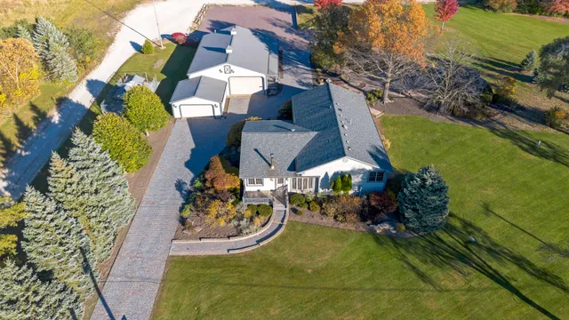 an aerial view of a house with a garden and trees