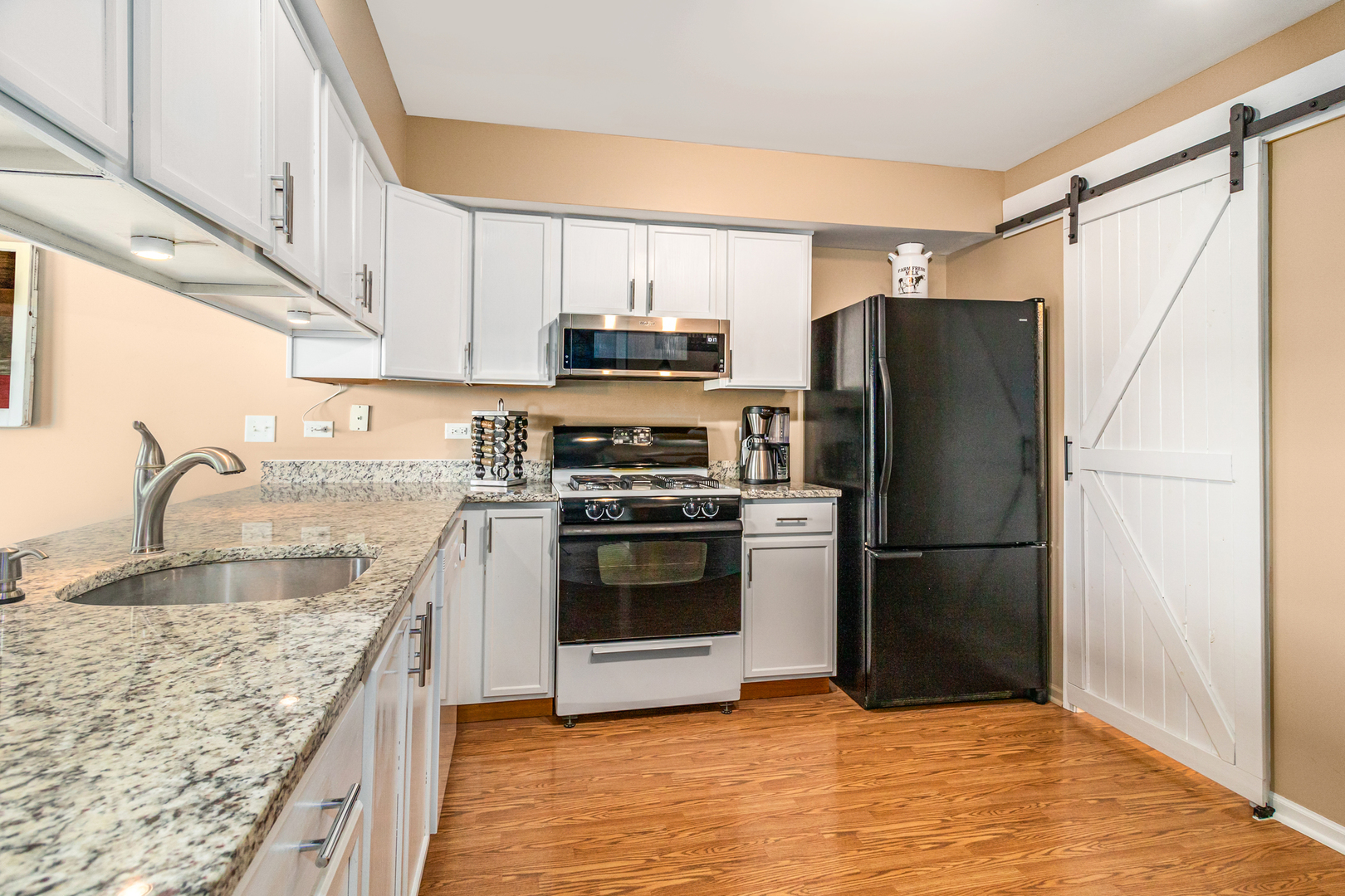 25151 Faraday Road Manhattan, IL 60442 - Photo 3 of 13 a kitchen with granite countertop a refrigerator stove and sink