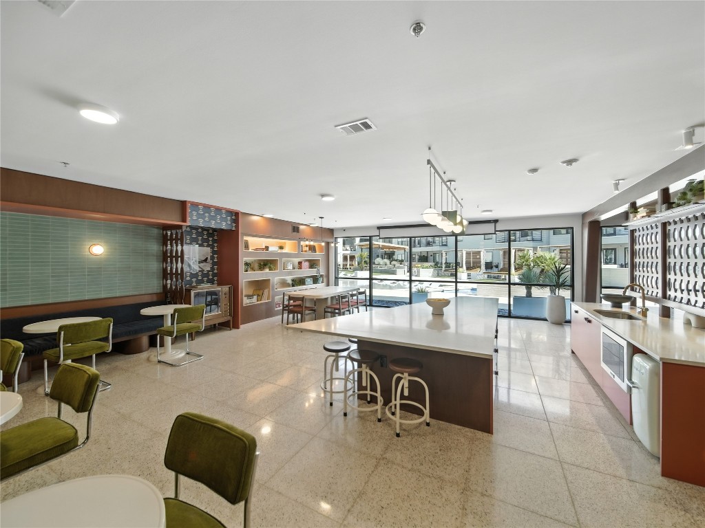 1701 Simond Avenue, Unit 302 Austin, TX 78723 - Photo 11 of 26 a kitchen with a sink and chairs