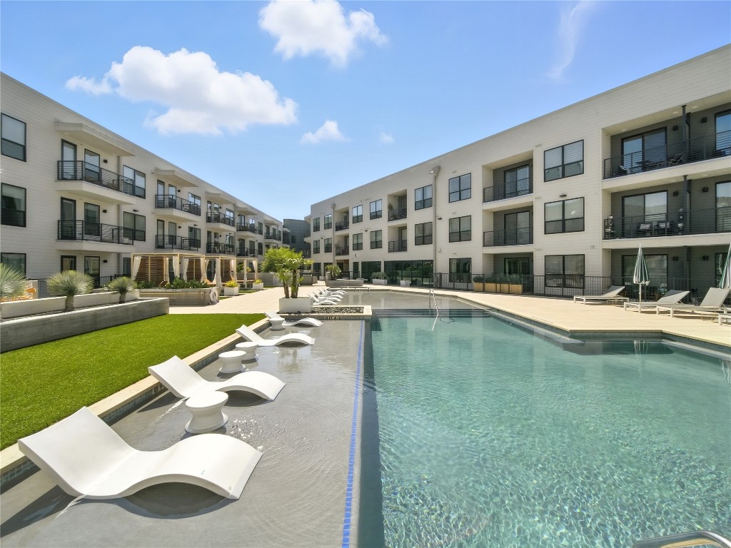 1701 Simond Avenue, Unit 302 Austin, TX 78723 - Photo 16 of 26 a swimming pool with outdoor seating and yard