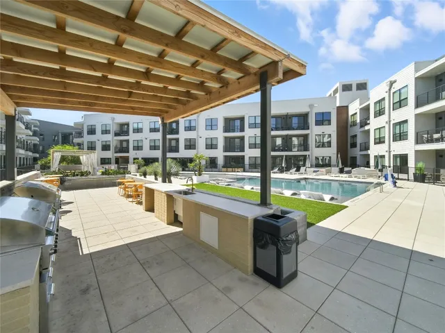 a swimming pool with outdoor seating and yard
