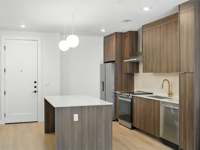 a kitchen with cabinets and a table