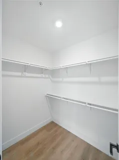 an empty room with wooden floor and a window