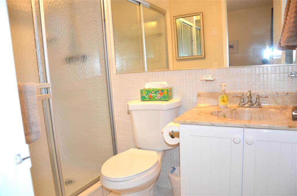 255 South Cypress Road, Unit 342 Pompano Beach, FL 33060 - Photo 13 of 23 a bathroom with a sink a toilet and shower