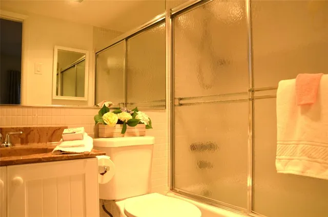 a bathroom with a sink toilet and shower