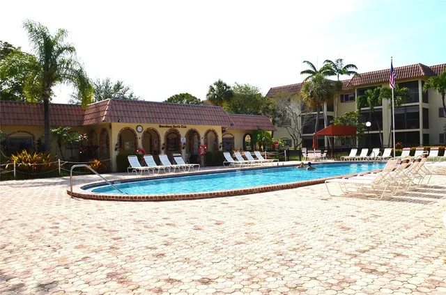 a view of swimming pool and outdoor seating