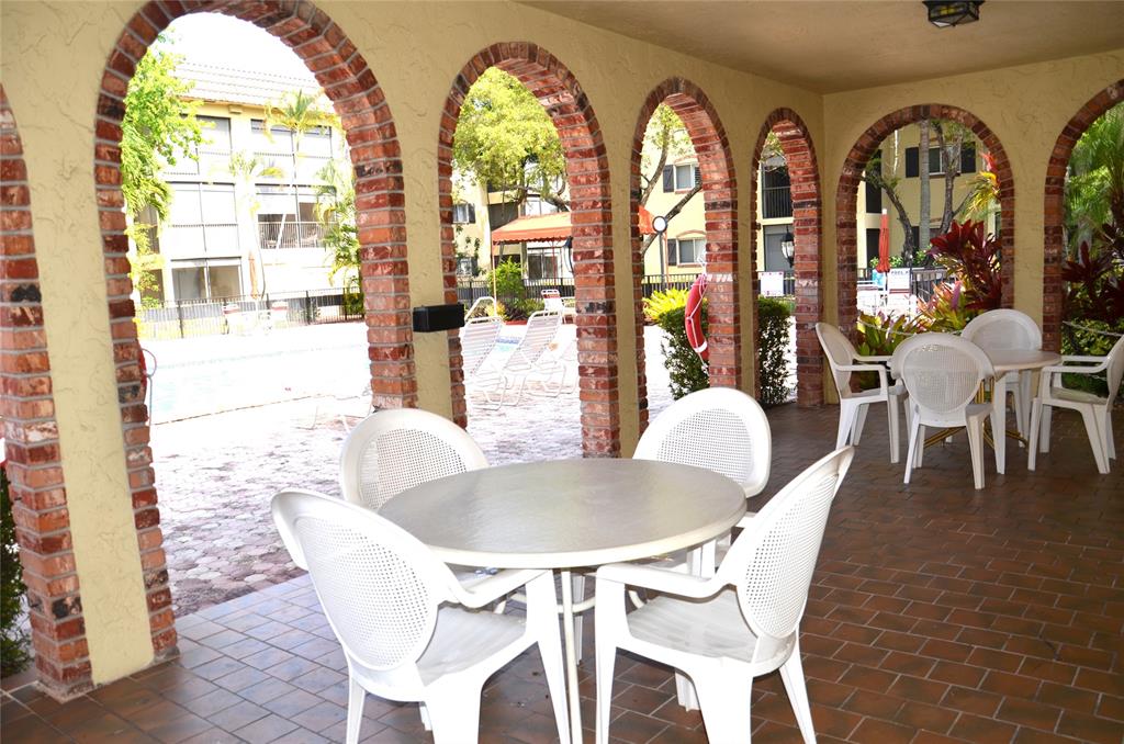 255 South Cypress Road, Unit 342 Pompano Beach, FL 33060 - Photo 22 of 23 a view of a dining room with furniture and chandelier