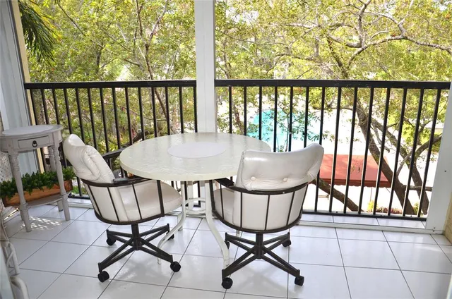 a view of a chairs and table in the balcony