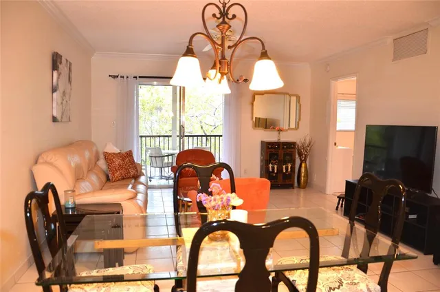a living room with fireplace furniture and a large window