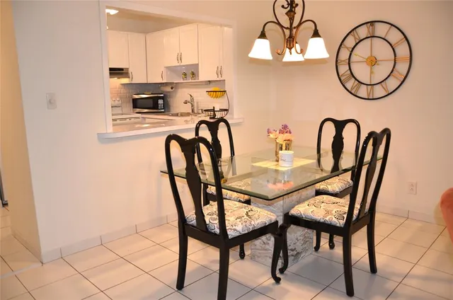 a dining room with furniture and a mirror