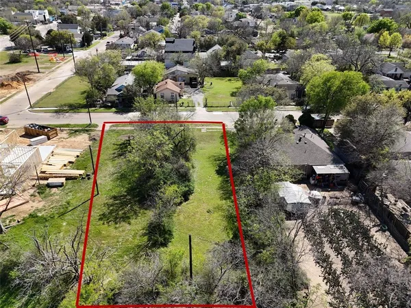 an aerial view of residential house with outdoor space and trees all around