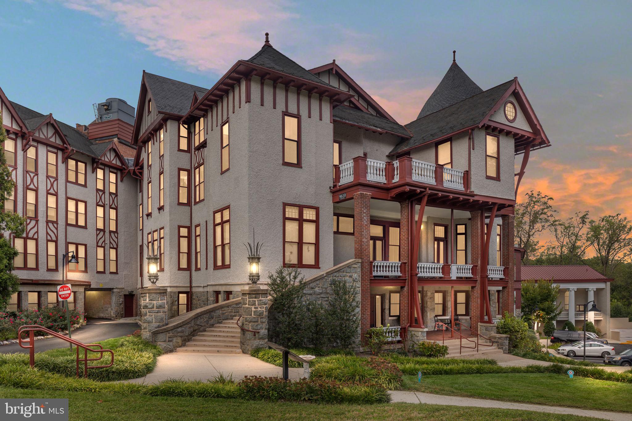 a front view of a residential apartment building with a yard
