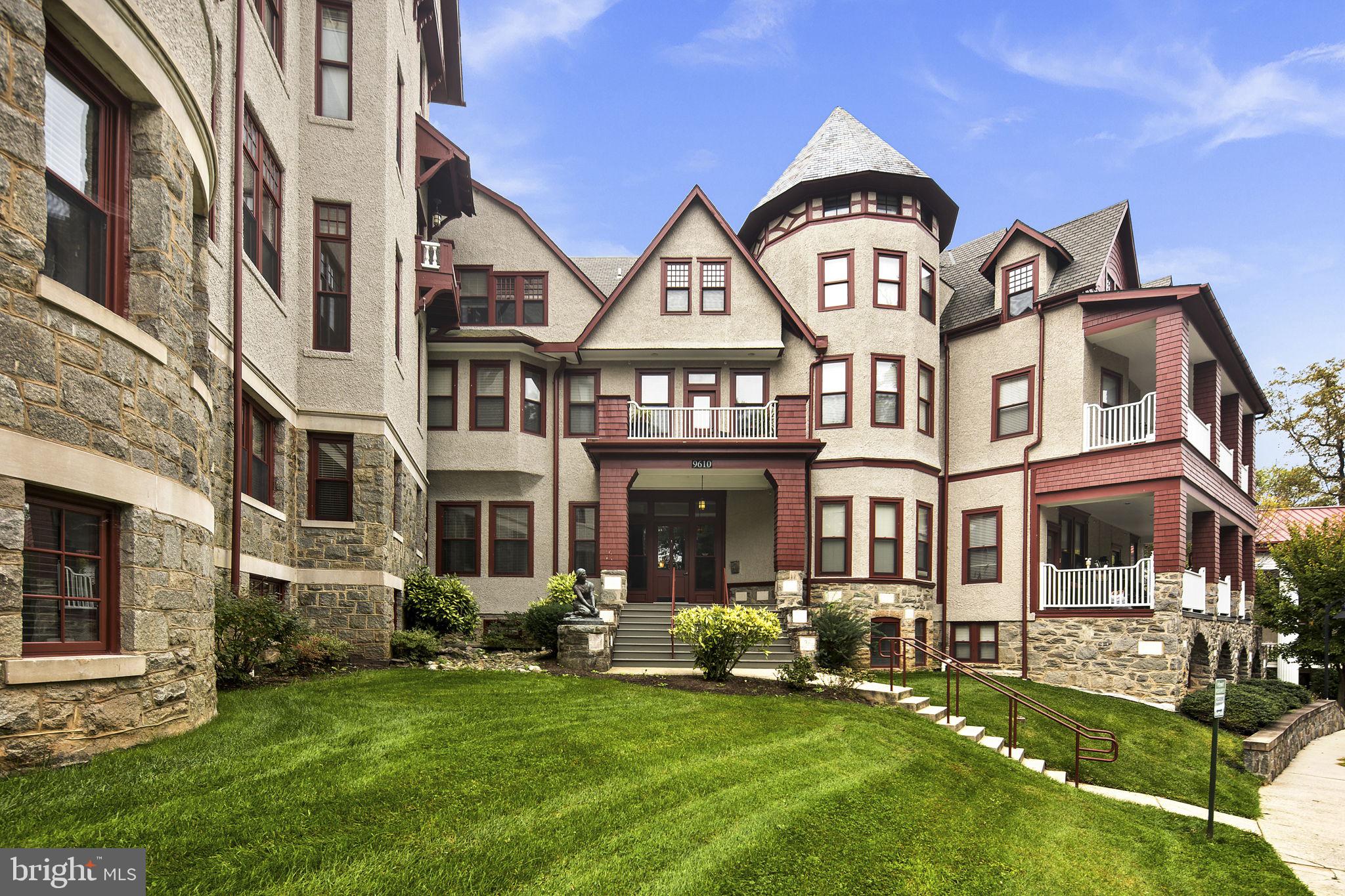 9610 Dewitt Drive, Unit PH204 Silver Spring, MD 20910 - Photo 11 of 42 a front view of a residential apartment building with a yard