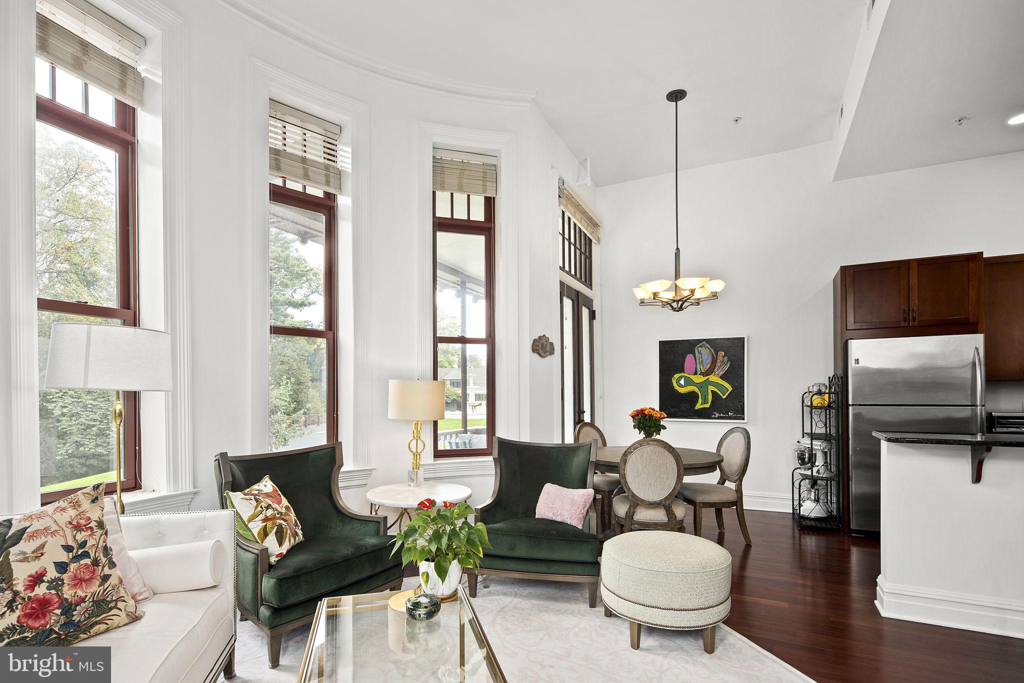 9610 Dewitt Drive, Unit PH204 Silver Spring, MD 20910 - Photo 17 of 42 a living room with furniture a fireplace and a flat screen tv