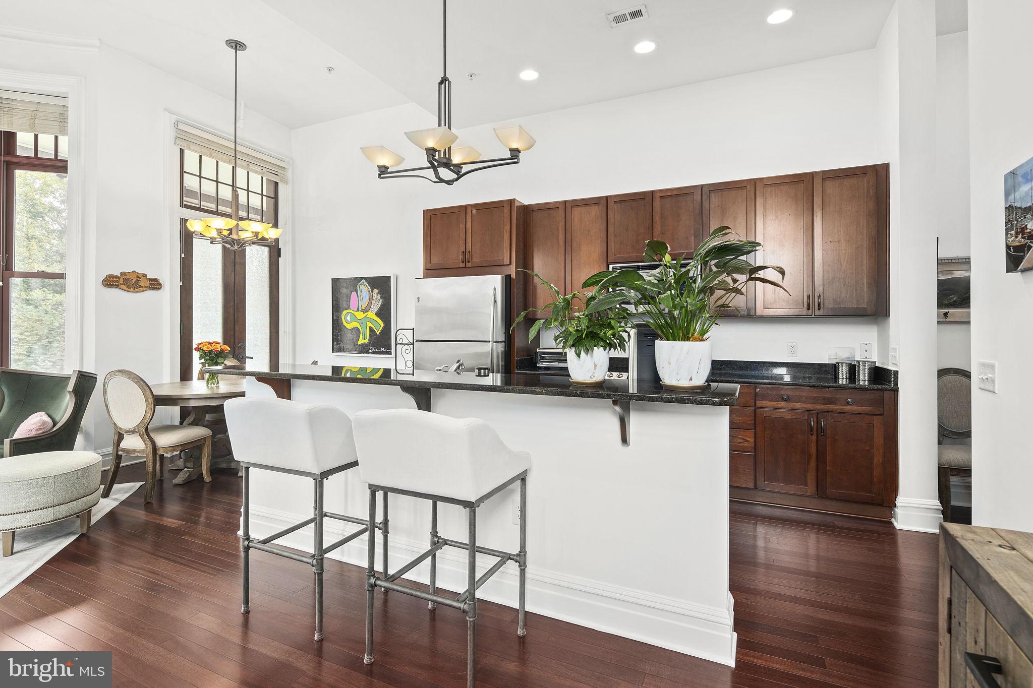 9610 Dewitt Drive, Unit PH204 Silver Spring, MD 20910 - Photo 26 of 42 a kitchen with a table and chairs in it