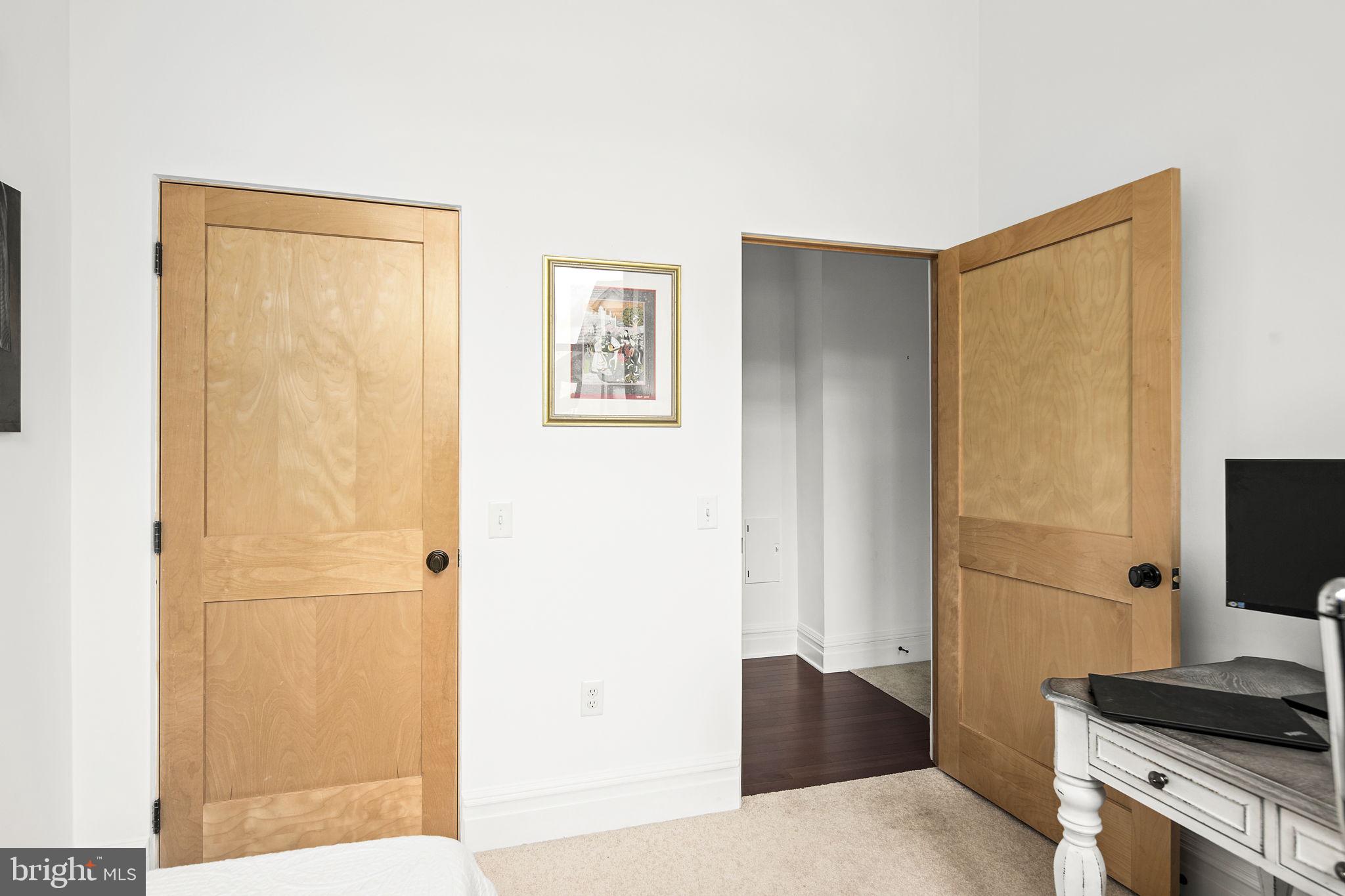 9610 Dewitt Drive, Unit PH204 Silver Spring, MD 20910 - Photo 29 of 42 a bedroom with a bed and a flat screen tv