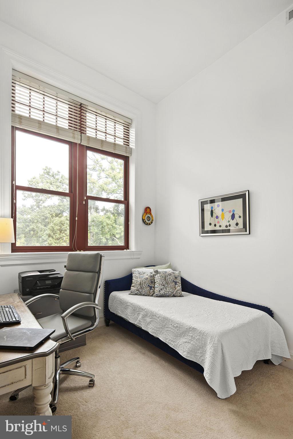 9610 Dewitt Drive, Unit PH204 Silver Spring, MD 20910 - Photo 30 of 42 a bedroom with a bed and a window