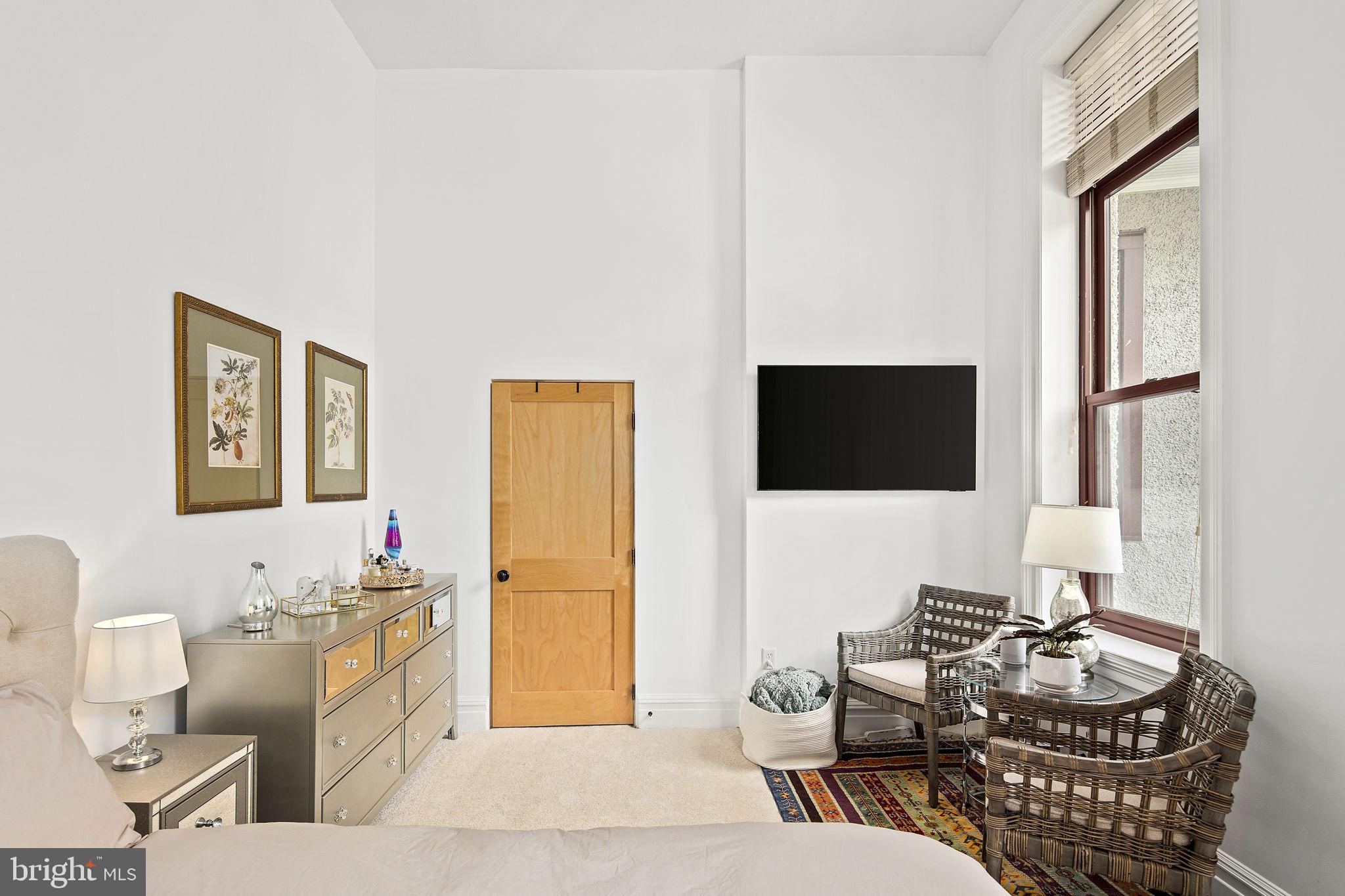 9610 Dewitt Drive, Unit PH204 Silver Spring, MD 20910 - Photo 34 of 42 a living room with furniture and a flat screen tv