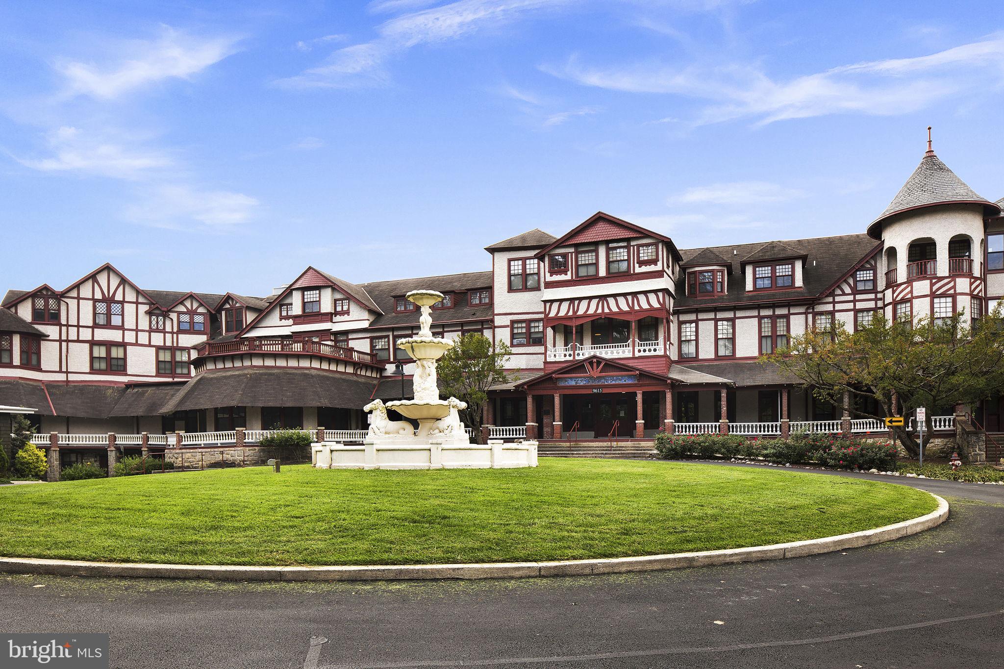 9610 Dewitt Drive, Unit PH204 Silver Spring, MD 20910 - Photo 37 of 42 a front view of a residential apartment building with a yard