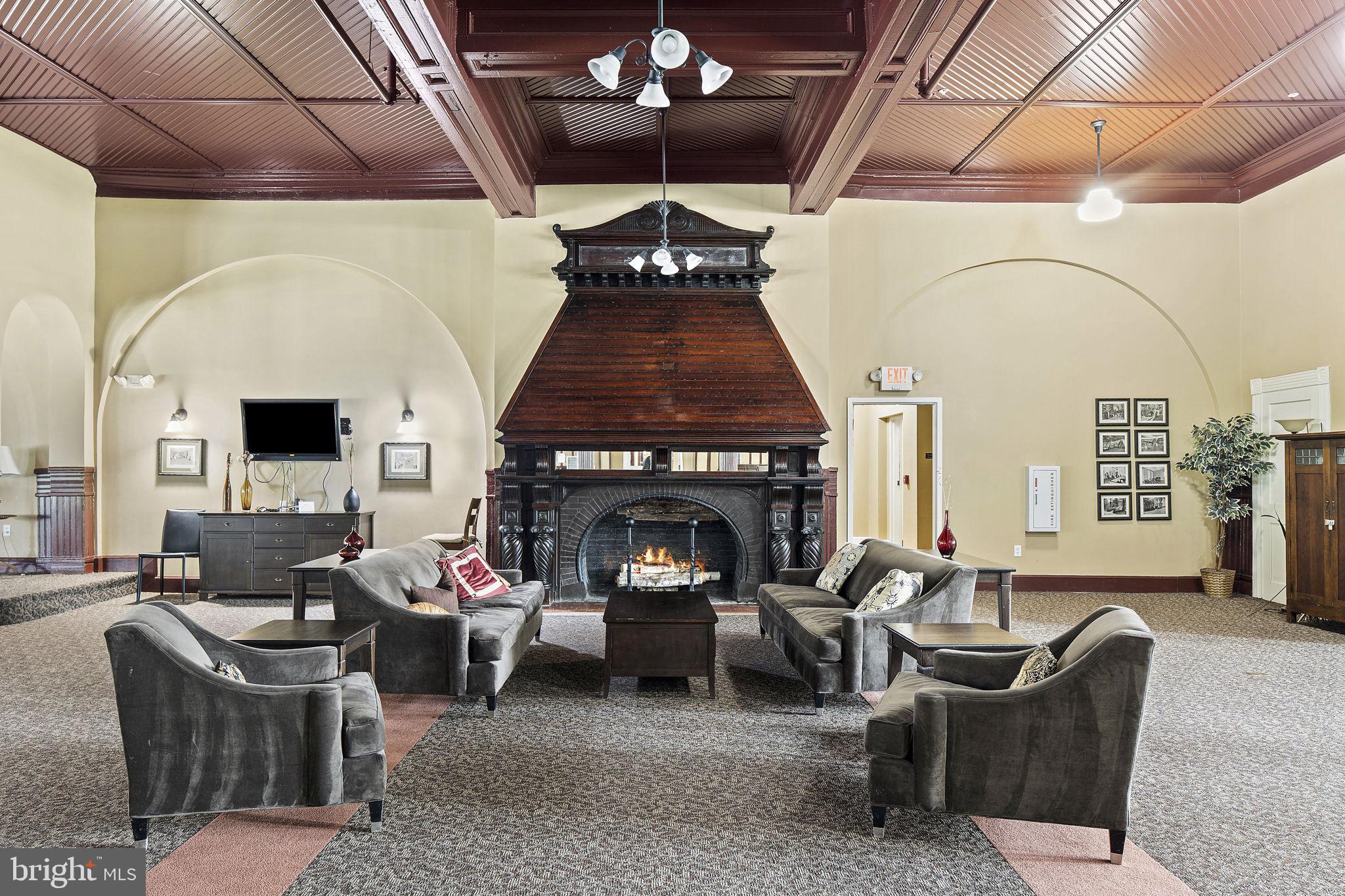 9610 Dewitt Drive, Unit PH204 Silver Spring, MD 20910 - Photo 39 of 42 a living room with furniture and a fireplace