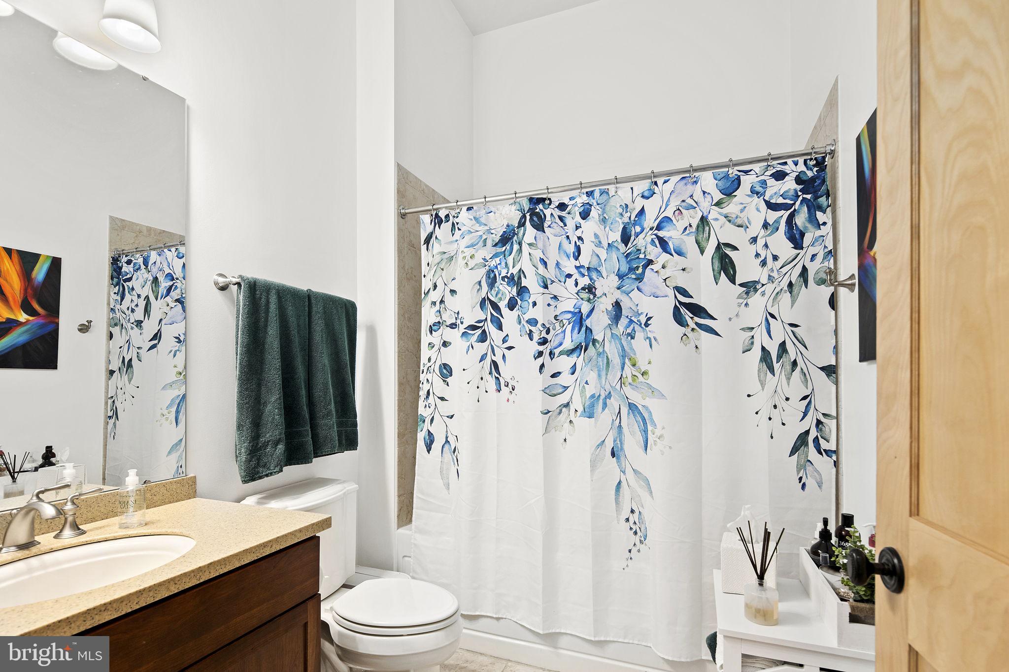 9610 Dewitt Drive, Unit PH204 Silver Spring, MD 20910 - Photo 7 of 42 a bathroom with a sink toilet and shower