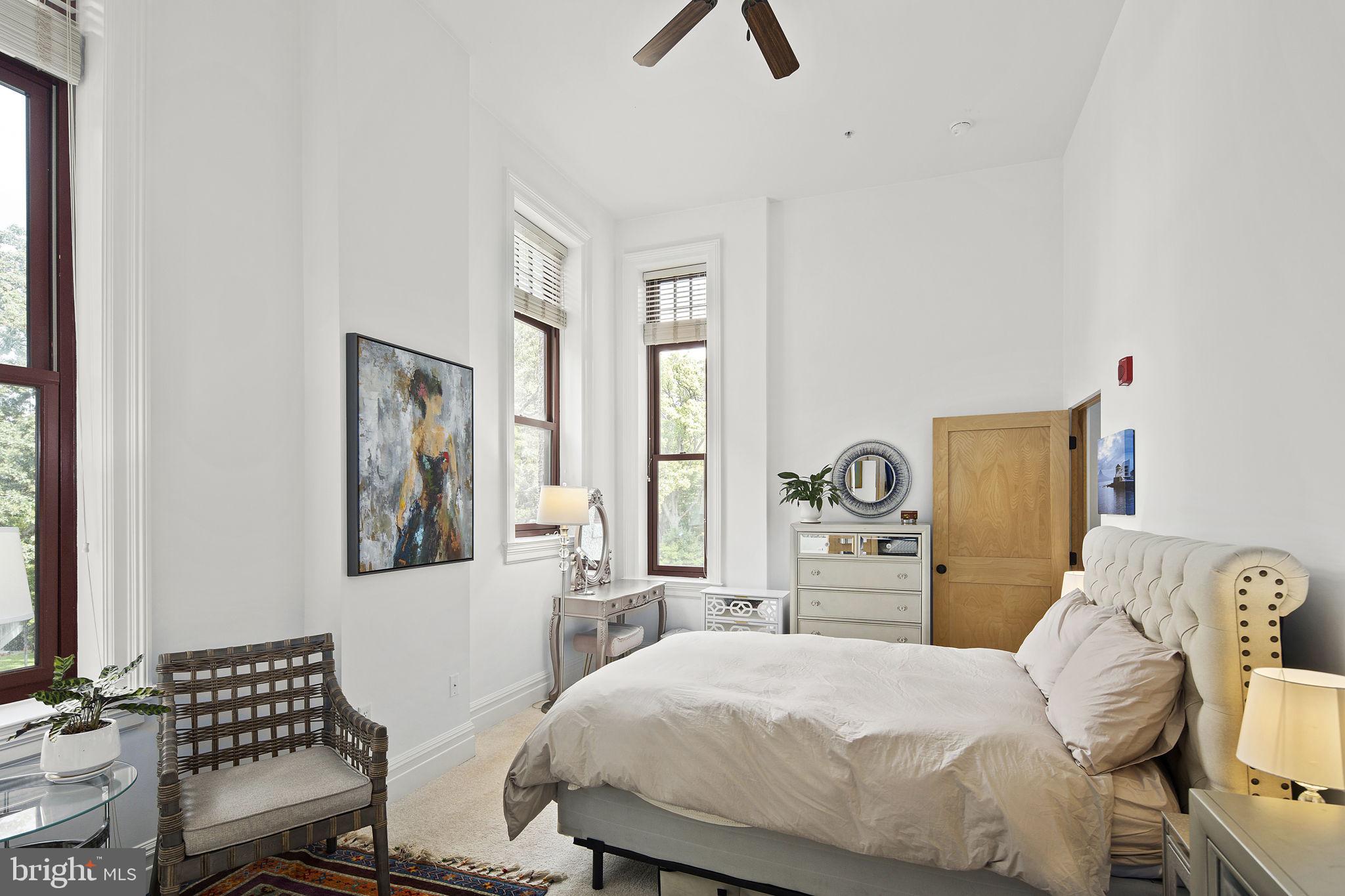 9610 Dewitt Drive, Unit PH204 Silver Spring, MD 20910 - Photo 8 of 42 a bedroom with a bed and wooden floor