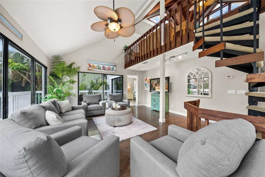1256 Riegels Landing Drive Sarasota, FL 34242 - Photo 11 of 40 a living room with furniture a chandelier and a large window