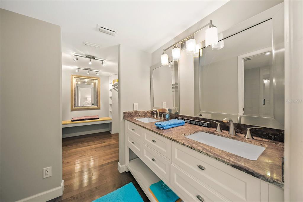 1256 Riegels Landing Drive Sarasota, FL 34242 - Photo 16 of 40 a bathroom with a granite countertop double vanity sink and mirror