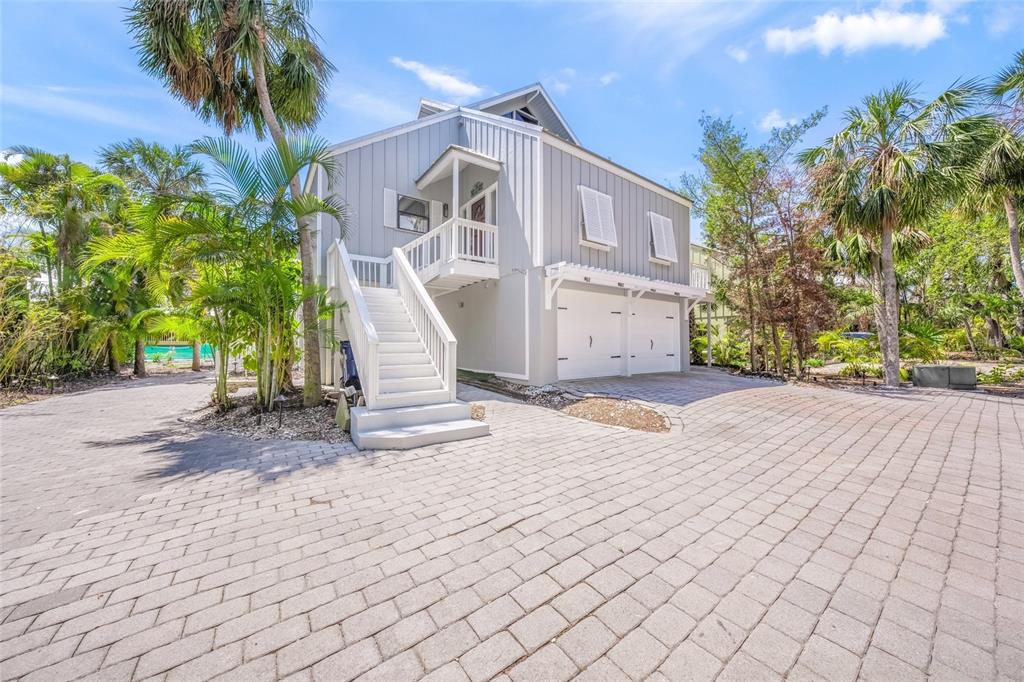 1256 Riegels Landing Drive Sarasota, FL 34242 - Photo 2 of 40 a front view of a house with a yard and a garage
