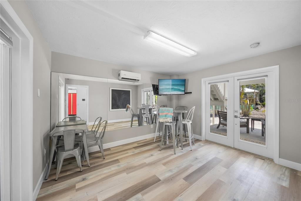 1256 Riegels Landing Drive Sarasota, FL 34242 - Photo 27 of 40 a dining room with wooden floor and glass door