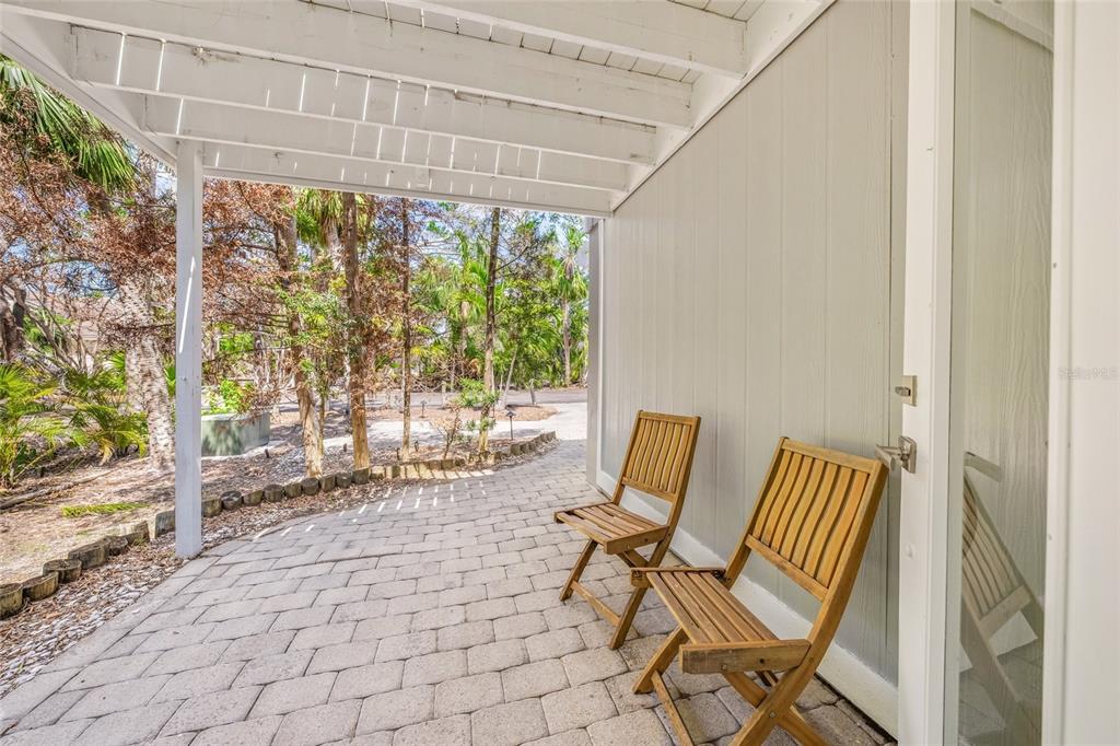1256 Riegels Landing Drive Sarasota, FL 34242 - Photo 30 of 40 a view of chair and bench in the porch