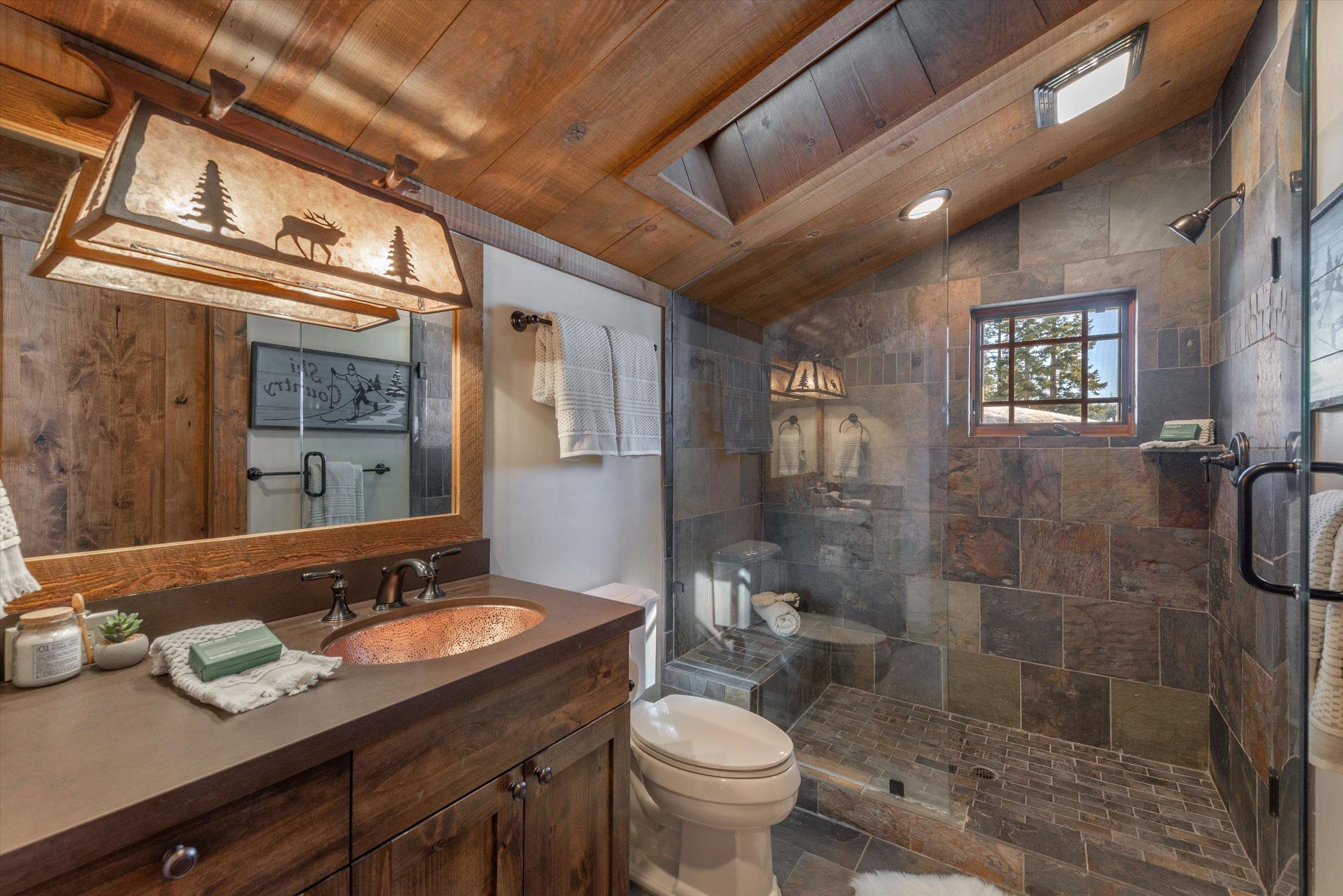 1756 Grouse Ridge Road Truckee, CA 96161 - Photo 17 of 21 a bathroom with a granite countertop sink a toilet a mirror and shower
