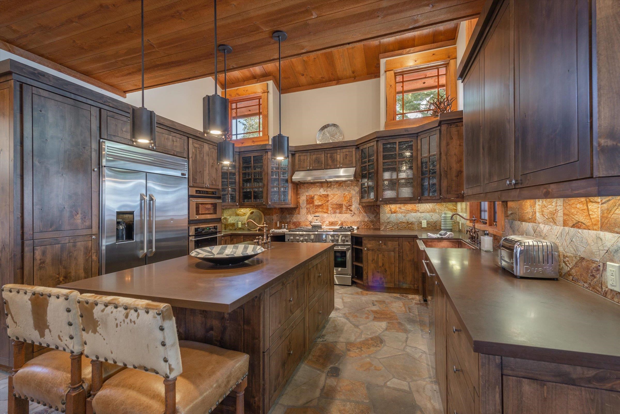 1756 Grouse Ridge Road Truckee, CA 96161 - Photo 7 of 21 a kitchen with stainless steel appliances granite countertop a sink and a refrigerator