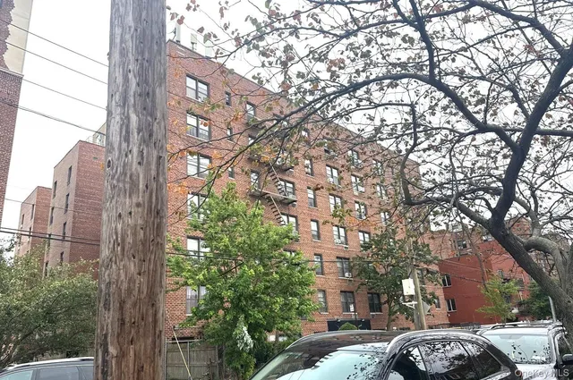 a couple of cars parked in front of a building