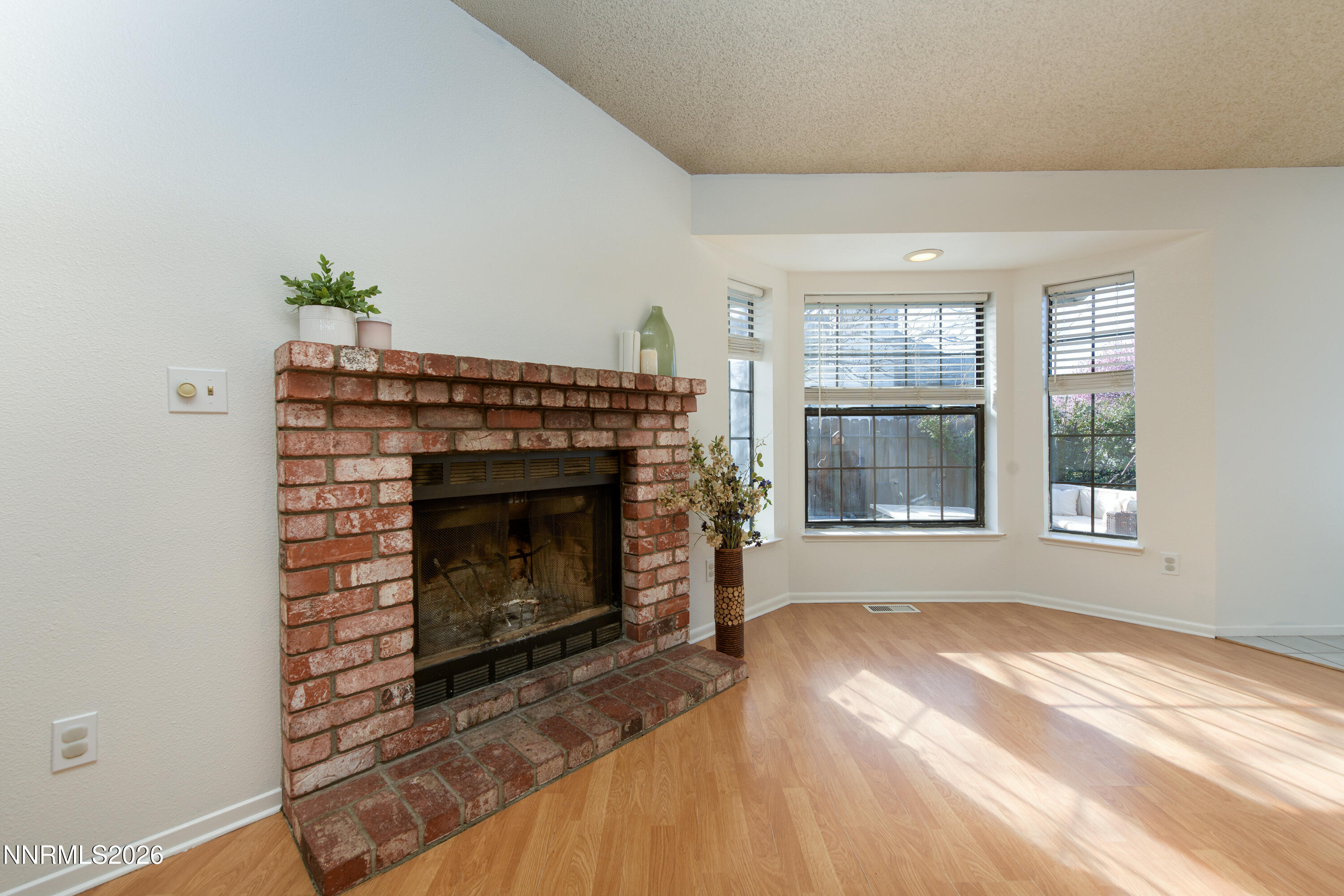 1352 Leonard Road Gardnerville, NV 89460 - Photo 15 of 23 a living room with a fireplace in front of a window