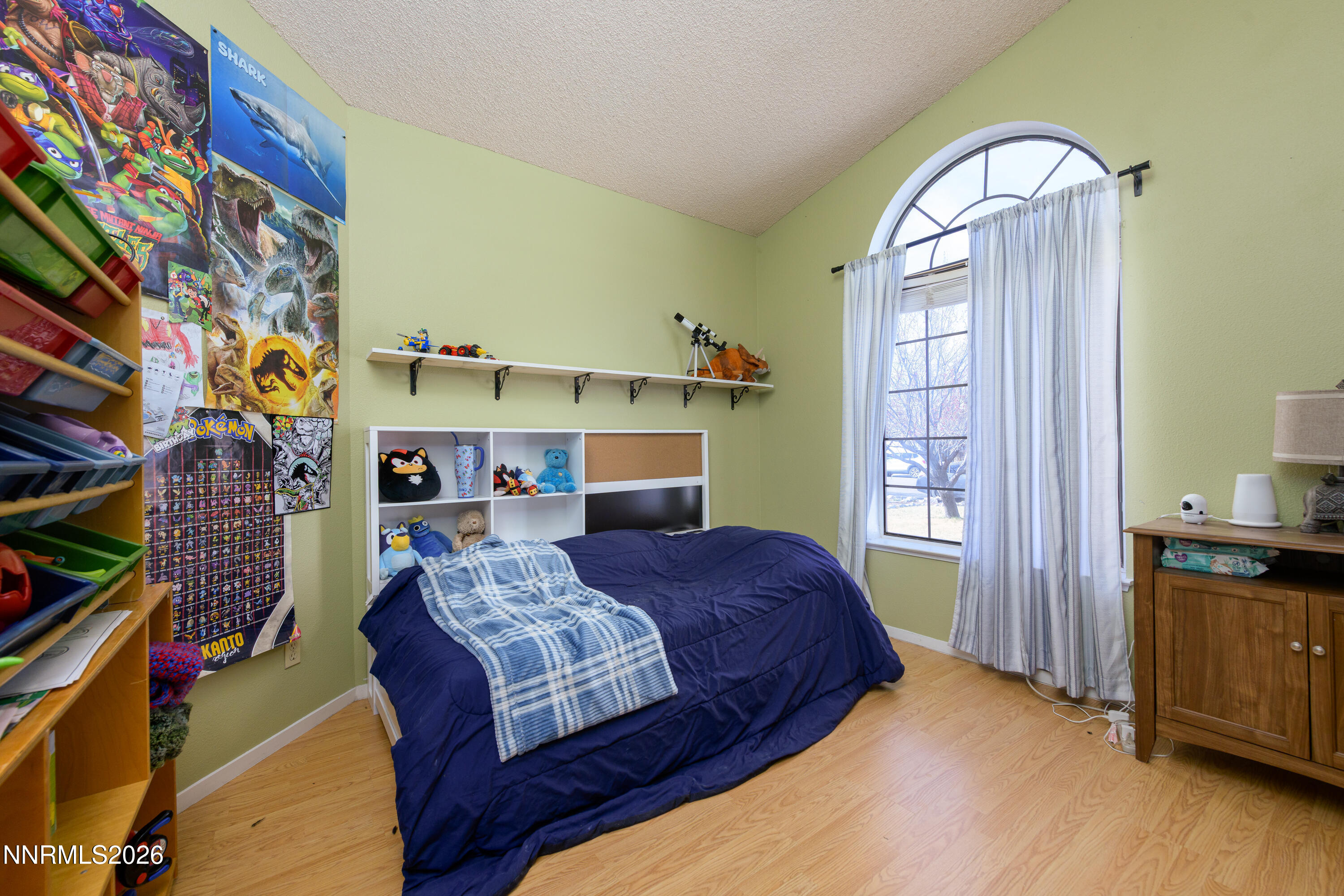 1352 Leonard Road Gardnerville, NV 89460 - Photo 16 of 23 a bedroom with a bed and a chandelier