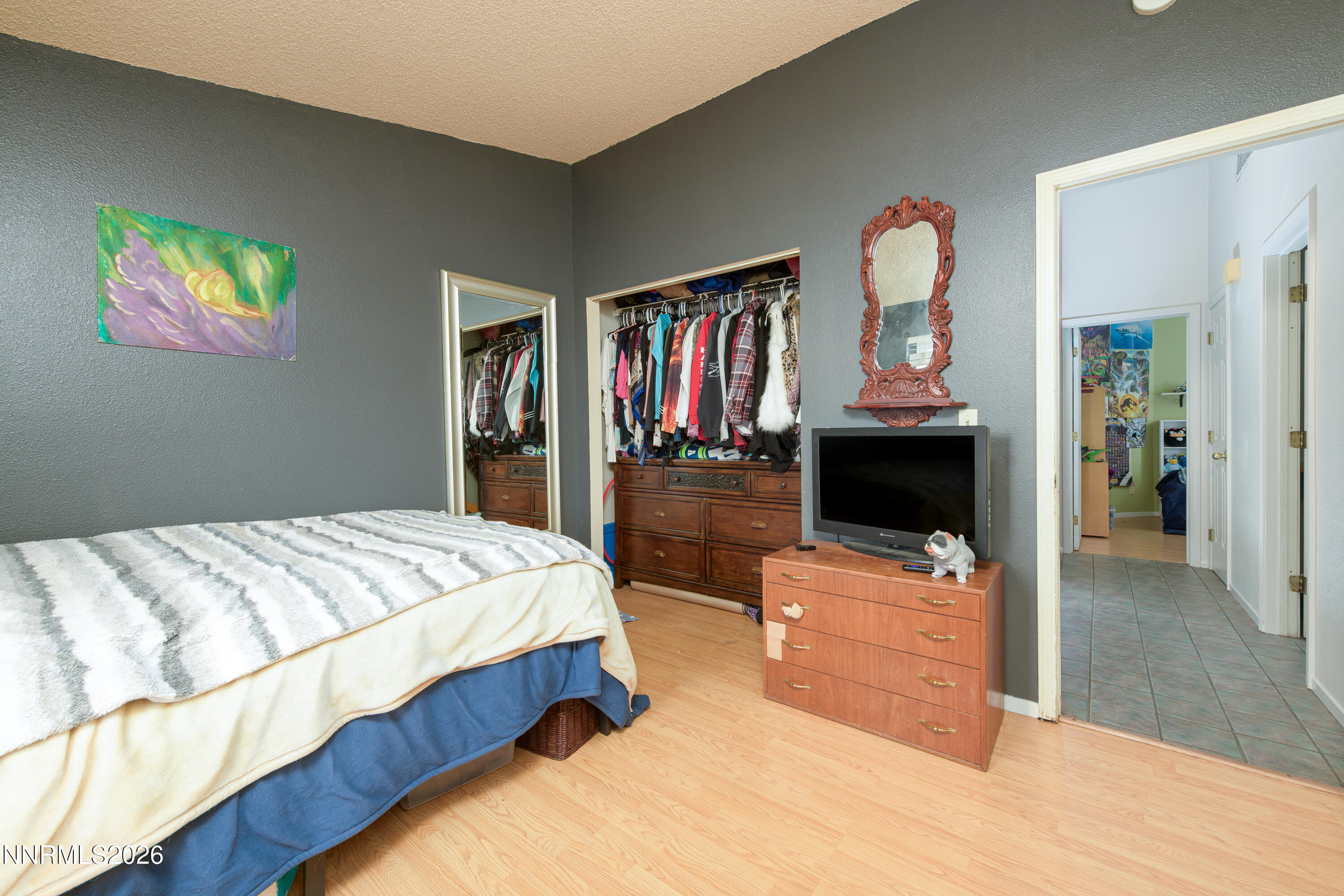 1352 Leonard Road Gardnerville, NV 89460 - Photo 18 of 23 a bedroom with a bed and wooden floor