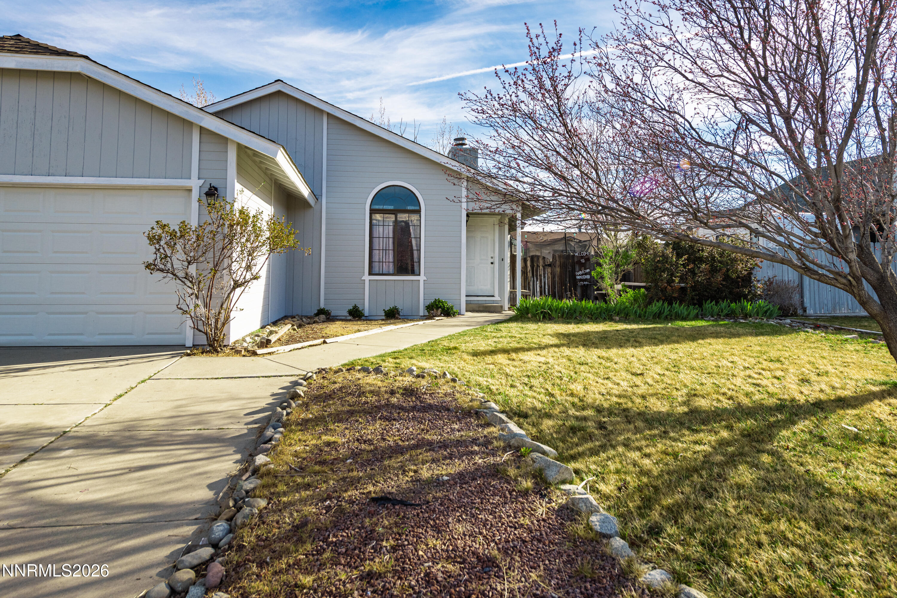1352 Leonard Road Gardnerville, NV 89460 - Photo 20 of 23 a view of a white house with a yard and pathway