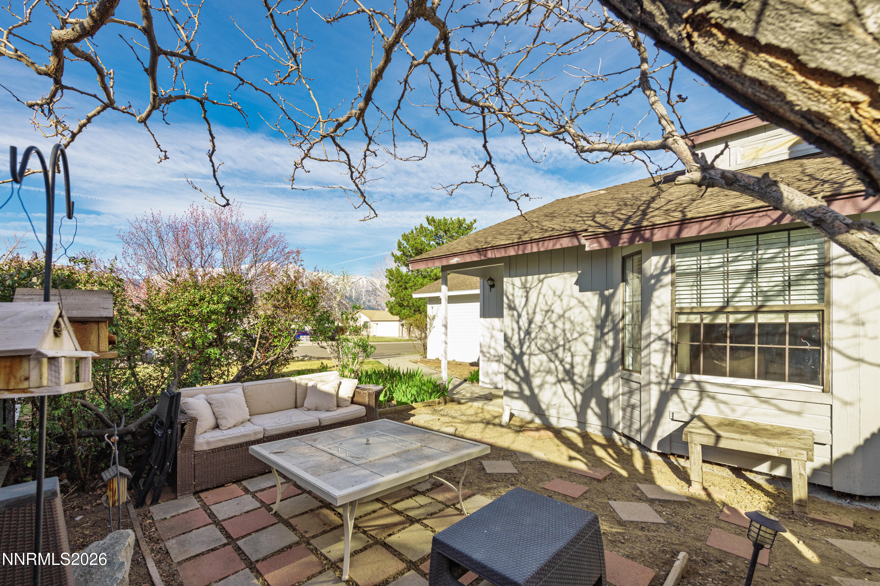 1352 Leonard Road Gardnerville, NV 89460 - Photo 4 of 23 a view of a patio with couches and table and chairs with wooden floor and fence