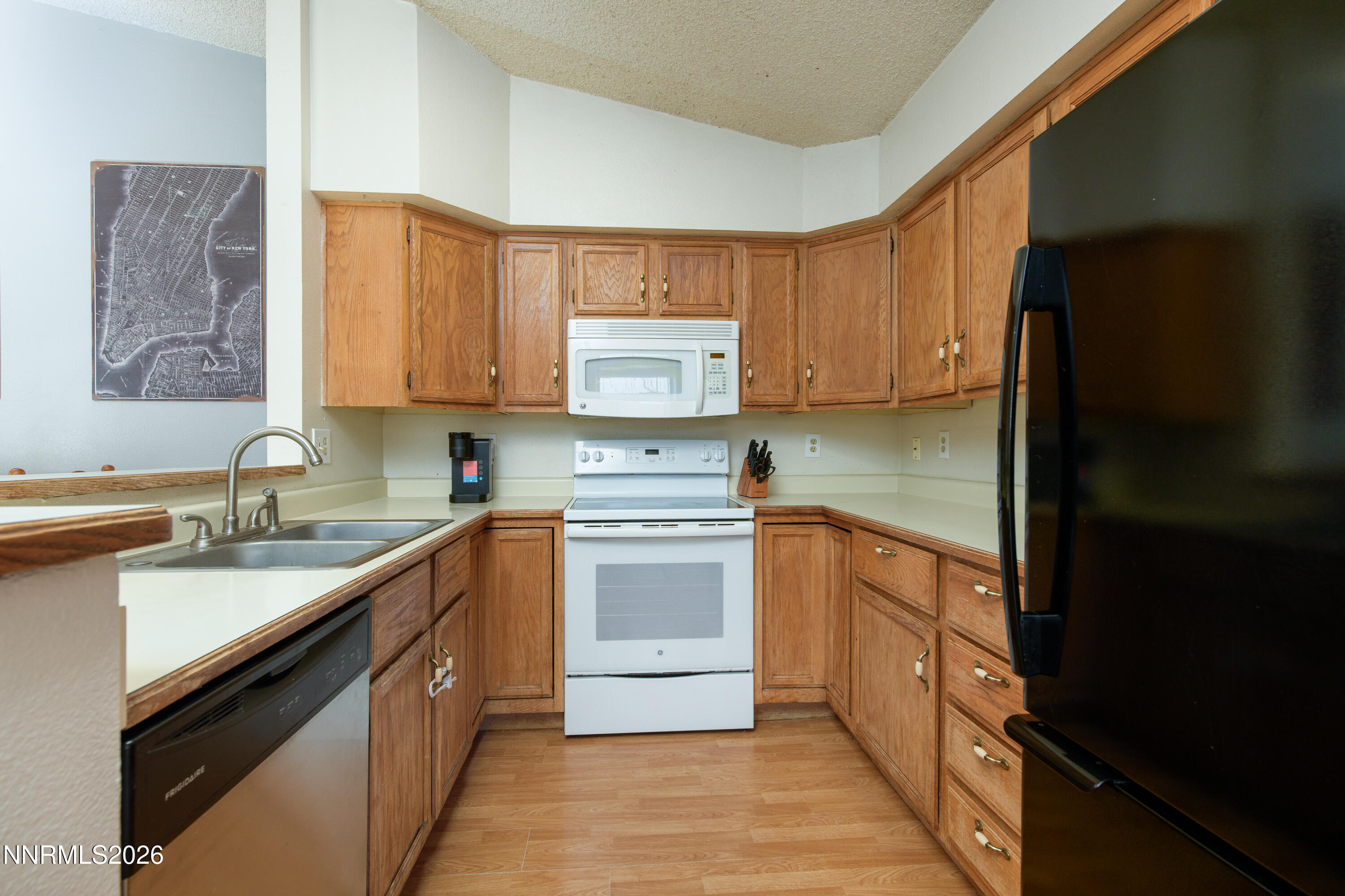 1352 Leonard Road Gardnerville, NV 89460 - Photo 7 of 23 a kitchen with stainless steel appliances granite countertop a sink stove and refrigerator
