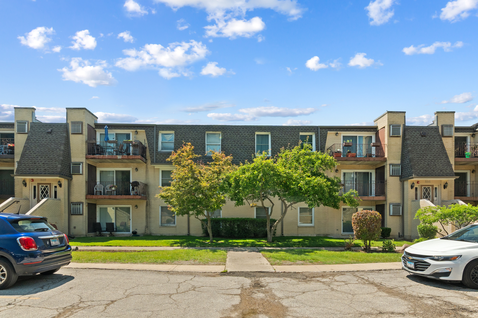 808 North River Road, Unit 2A Mount Prospect, IL 60056 - Photo 1 of 22 a front view of residential houses with yard and green space