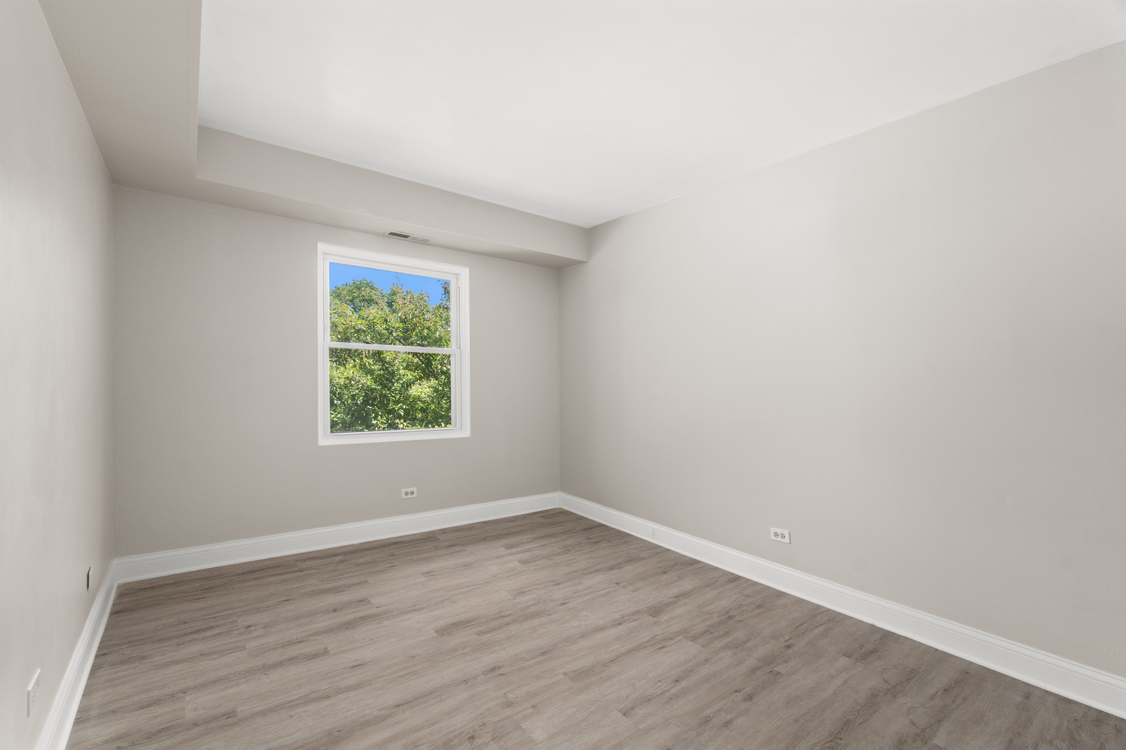 808 North River Road, Unit 2A Mount Prospect, IL 60056 - Photo 17 of 22 an empty room with wooden floor and windows