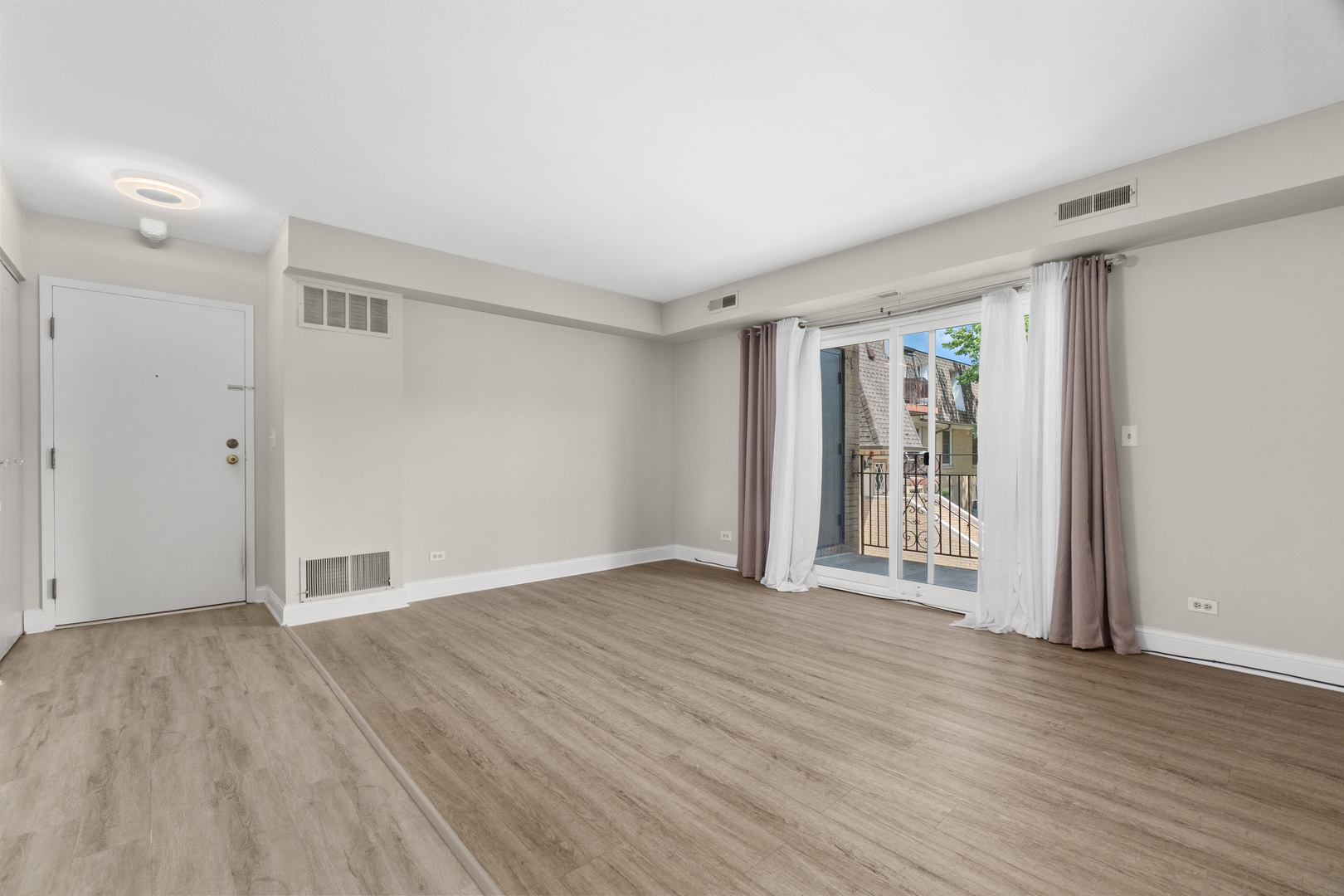808 North River Road, Unit 2A Mount Prospect, IL 60056 - Photo 3 of 22 a view of an empty room with wooden floor