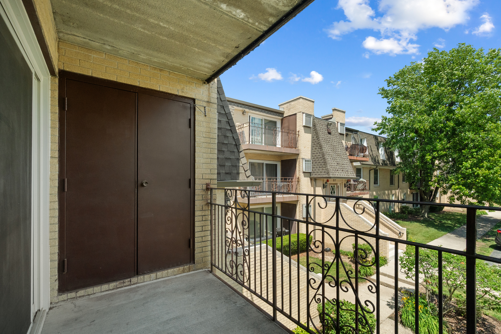 808 North River Road, Unit 2A Mount Prospect, IL 60056 - Photo 6 of 22 a view of a brick house with a small yard